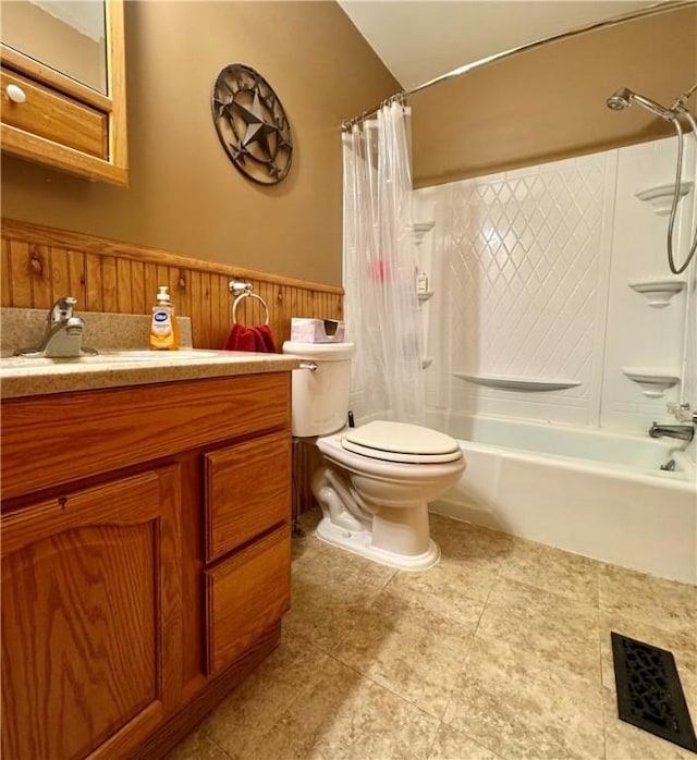 bathroom with tile patterned floors, toilet, shower / bathtub combination with curtain, and vanity