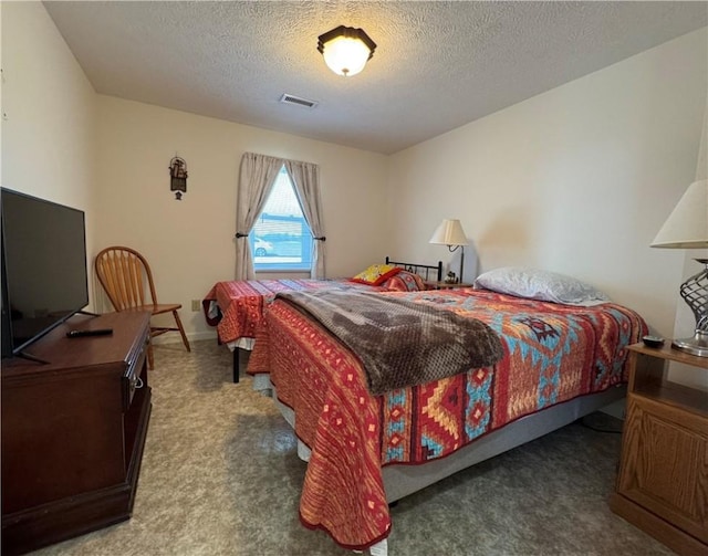 carpeted bedroom with visible vents and a textured ceiling
