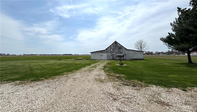 exterior space with a yard, an outdoor structure, and a barn