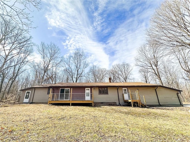 single story home with a deck and a front lawn