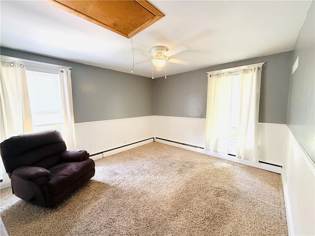 403 S 2nd Ave, Hoopeston, IL 60942 - living area with healthy amount of natural light, a wainscoted wall, carpet flooring, attic access, and ceiling fan