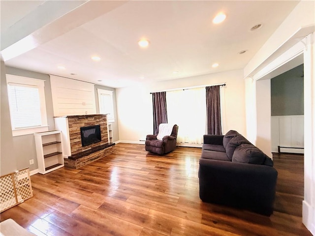 403 S 2nd Ave, Hoopeston, IL 60942 - living room featuring hardwood / wood-style floors, a baseboard radiator, a fireplace, and recessed lighting