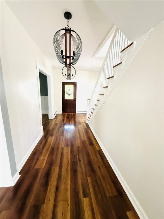 403 S 2nd Ave, Hoopeston, IL 60942 - entryway featuring a chandelier, baseboards, dark wood-type flooring, and stairway