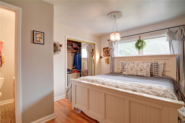 530 Sunset Dr, Mt Zion, IL 62549 - bedroom featuring a closet, light wood-type flooring, and baseboards