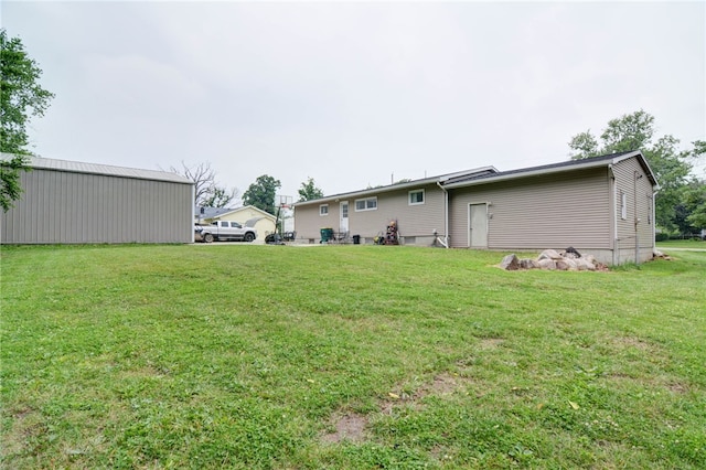 530 Sunset Dr, Mt Zion, IL 62549 - view of green lawn featuring a pole building and an outbuilding