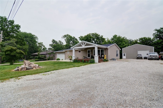 530 Sunset Dr, Mt Zion, IL 62549 - view of front facade with covered porch, a garage, and a front lawn