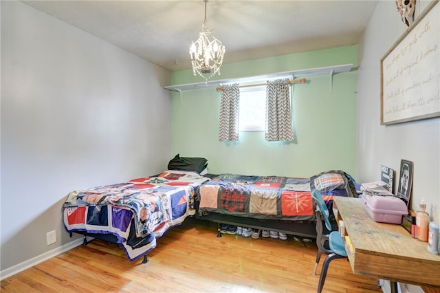 530 Sunset Dr, Mt Zion, IL 62549 - bedroom featuring a chandelier and wood finished floors