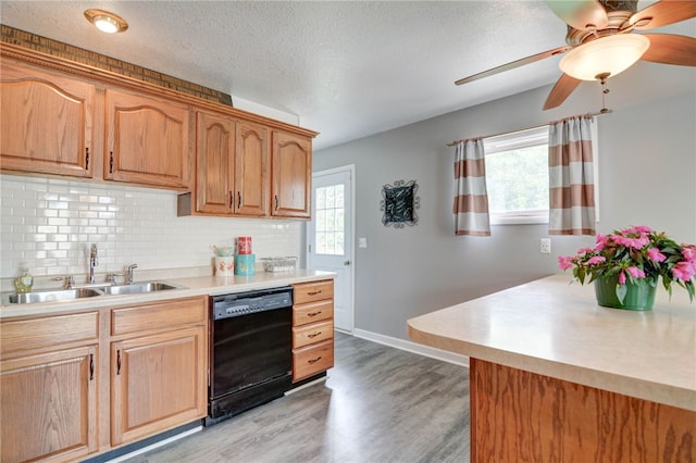 530 Sunset Dr, Mt Zion, IL 62549 - kitchen featuring dishwasher, a sink, plenty of natural light, light wood-style flooring, and a textured ceiling