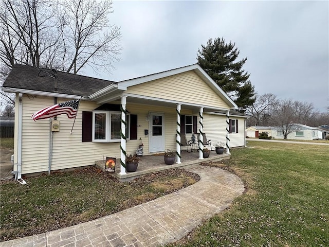 ranch-style house with a front yard and a porch