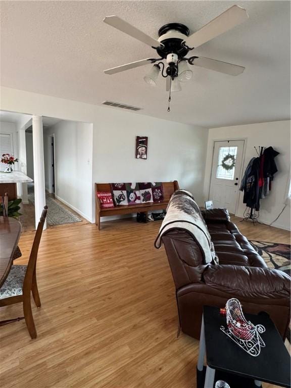 living room with ceiling fan and light wood-type flooring