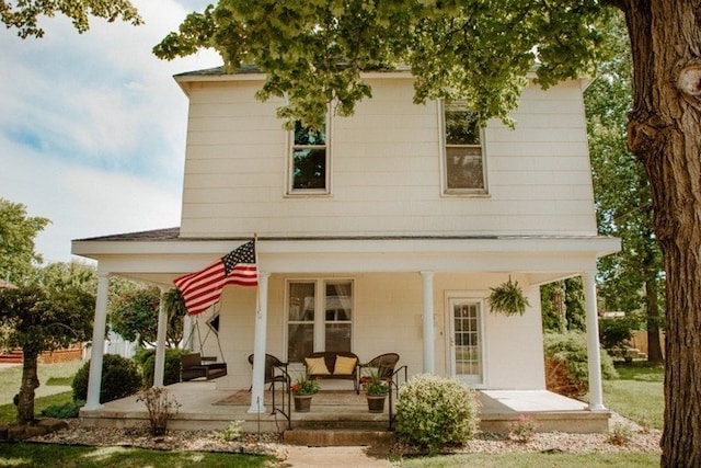 rear view of property featuring an outdoor hangout area