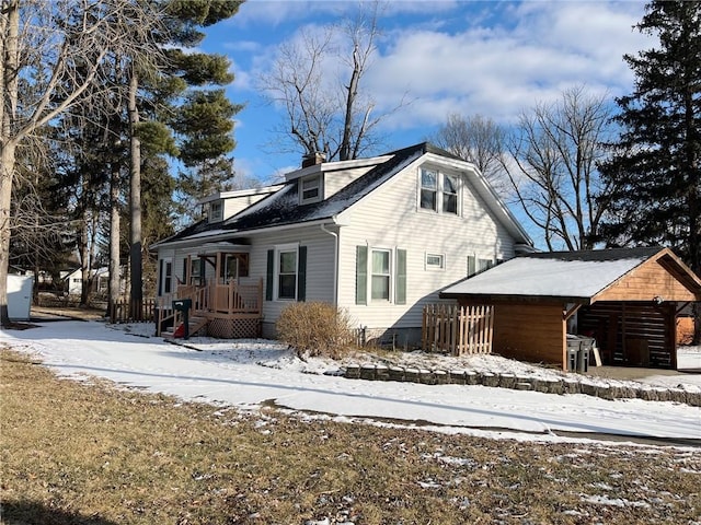 view of snow covered exterior featuring a chimney