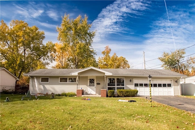 ranch-style house featuring a garage and a front yard