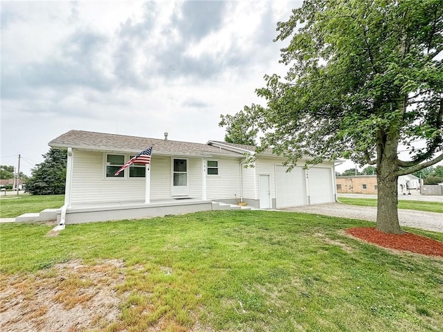106 N Jefferson St, Greenup, IL 62428 - ranch-style house with driveway, a porch, a front yard, and an attached garage