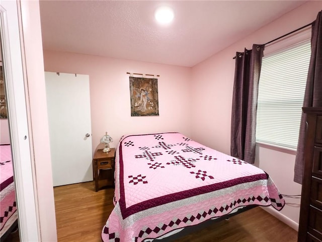 106 N Jefferson St, Greenup, IL 62428 - bedroom featuring wood finished floors and multiple windows