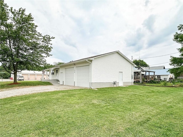 106 N Jefferson St, Greenup, IL 62428 - view of side of home with an attached garage, gravel driveway, and a lawn