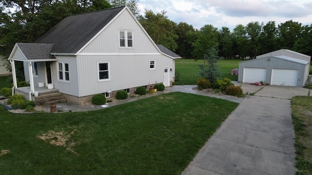 303 E Glenwood Ave, Olney, IL 62450 - view of side of home with a garage, an outdoor structure, a lawn, and roof with shingles