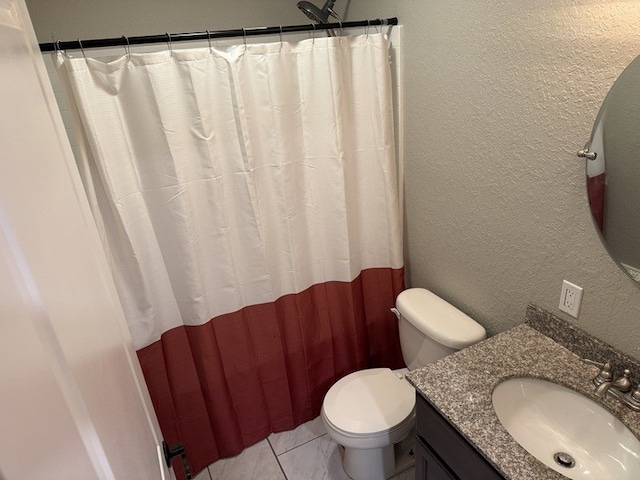 303 E Glenwood Ave, Olney, IL 62450 - full bath with a textured wall, toilet, vanity, and tile patterned flooring