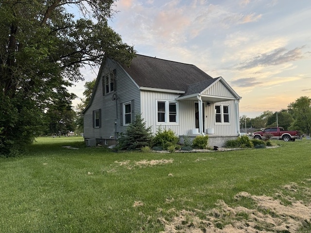 303 E Glenwood Ave, Olney, IL 62450 - view of front of house featuring board and batten siding, a porch, and a yard