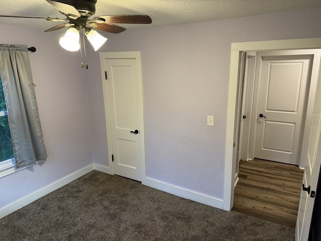 303 E Glenwood Ave, Olney, IL 62450 - unfurnished room with ceiling fan, dark colored carpet, and baseboards