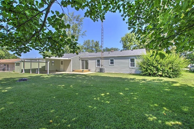 125 W Walnut St, Mt Zion, IL 62549 - back of house featuring a yard and a patio area