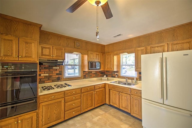 125 W Walnut St, Mt Zion, IL 62549 - kitchen with black appliances, a warming drawer, plenty of natural light, and light countertops