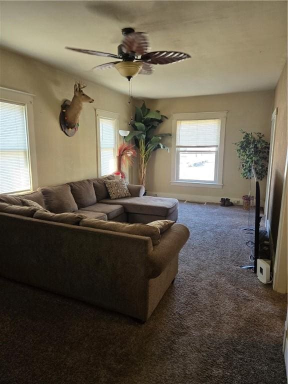 carpeted living room with ceiling fan