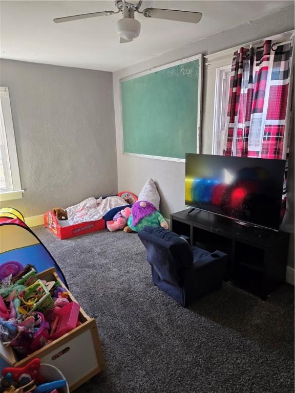 carpeted bedroom featuring ceiling fan