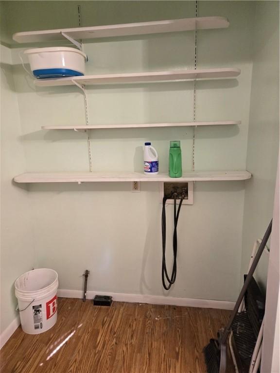 washroom with hookup for a washing machine, baseboards, and dark wood-style flooring