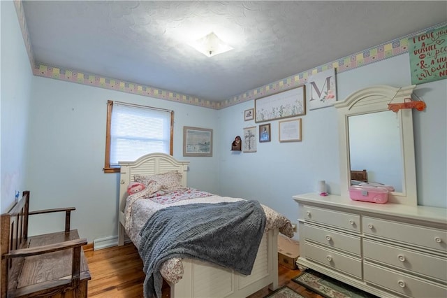 bedroom with light wood-type flooring and baseboards