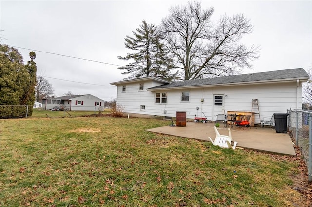 rear view of house featuring a patio area, a yard, and a fenced backyard