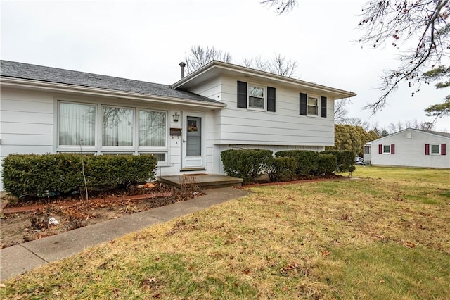 tri-level home with a front yard