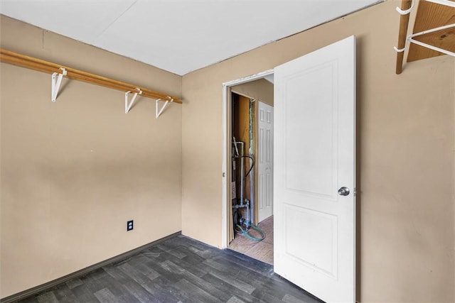 walk in closet featuring dark wood-style floors