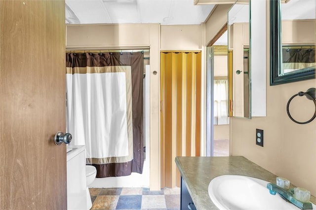 full bathroom featuring toilet and vanity