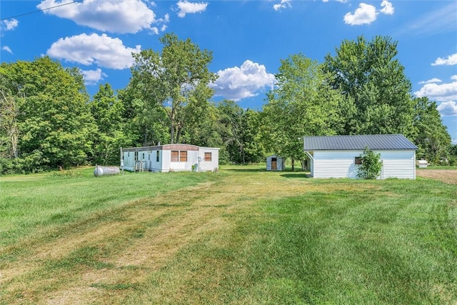 view of yard featuring an outbuilding and a shed