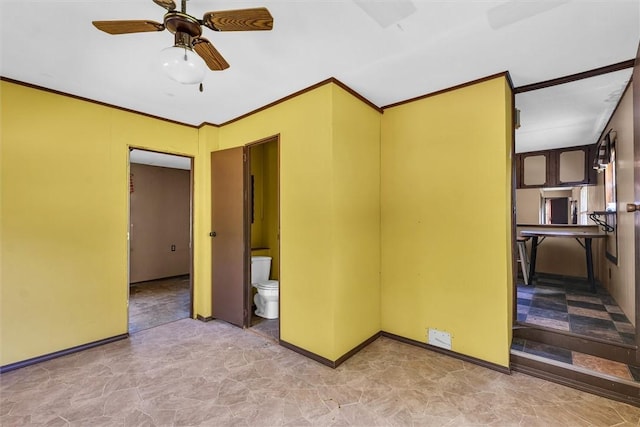 spare room with baseboards, ornamental molding, and ceiling fan