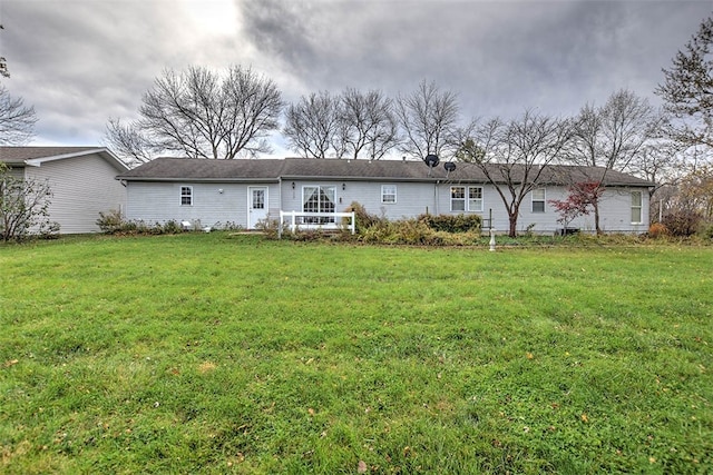 rear view of property with a yard