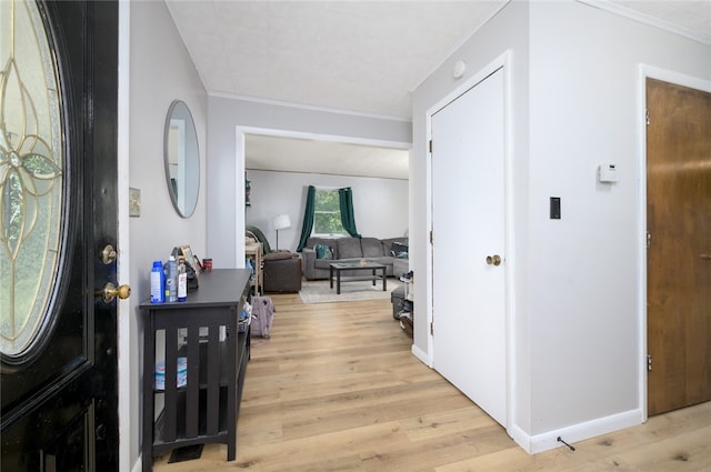 entryway featuring light hardwood / wood-style flooring and crown molding