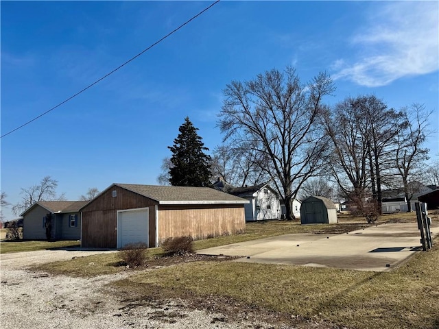 exterior space featuring an outbuilding, driveway, and a garage