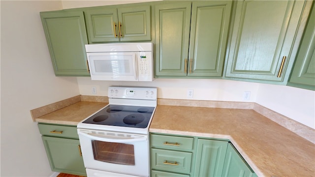 kitchen featuring white appliances, light countertops, and green cabinets