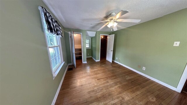 3728 N Lake Blvd, Danville, IL 61832 - unfurnished bedroom with baseboards, a textured ceiling, wood finished floors, and a ceiling fan