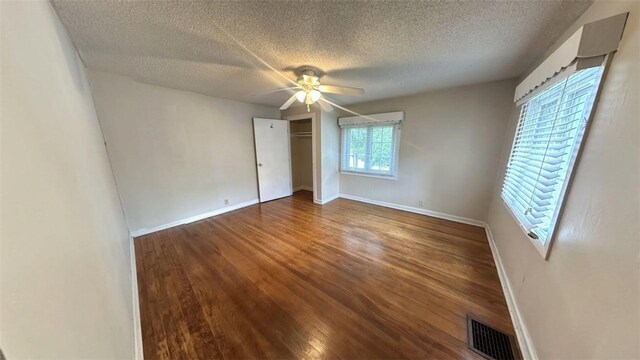 3728 N Lake Blvd, Danville, IL 61832 - unfurnished bedroom with a textured ceiling, wood finished floors, baseboards, a closet, and ceiling fan