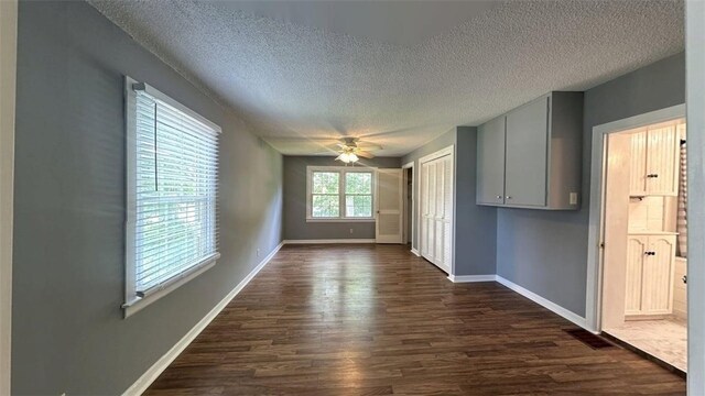 3728 N Lake Blvd, Danville, IL 61832 - spare room featuring a textured ceiling, dark wood-style floors, baseboards, and a ceiling fan