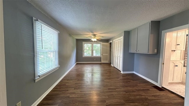 3728 N Lake Blvd, Danville, IL 61832 - unfurnished dining area featuring a textured ceiling, dark wood-style floors, ceiling fan, and baseboards
