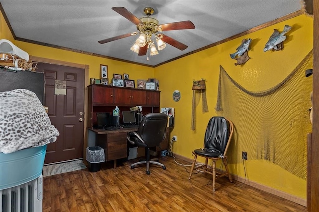 office area with ornamental molding, wood-type flooring, and ceiling fan