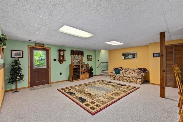 carpeted living room with a drop ceiling