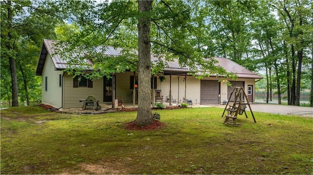 view of front of home featuring a garage and a front lawn