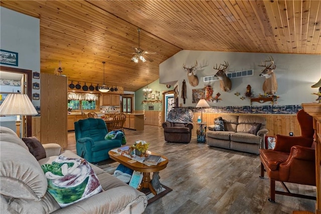 living room featuring ceiling fan, hardwood / wood-style floors, wooden walls, high vaulted ceiling, and wooden ceiling