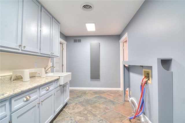 laundry area featuring washer hookup, a sink, visible vents, and baseboards