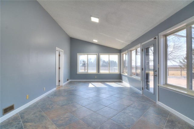 unfurnished room featuring lofted ceiling, plenty of natural light, visible vents, and baseboards